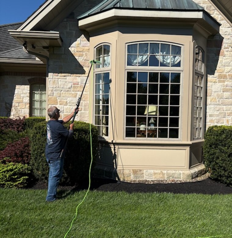 Window cleaning on a stone-front home