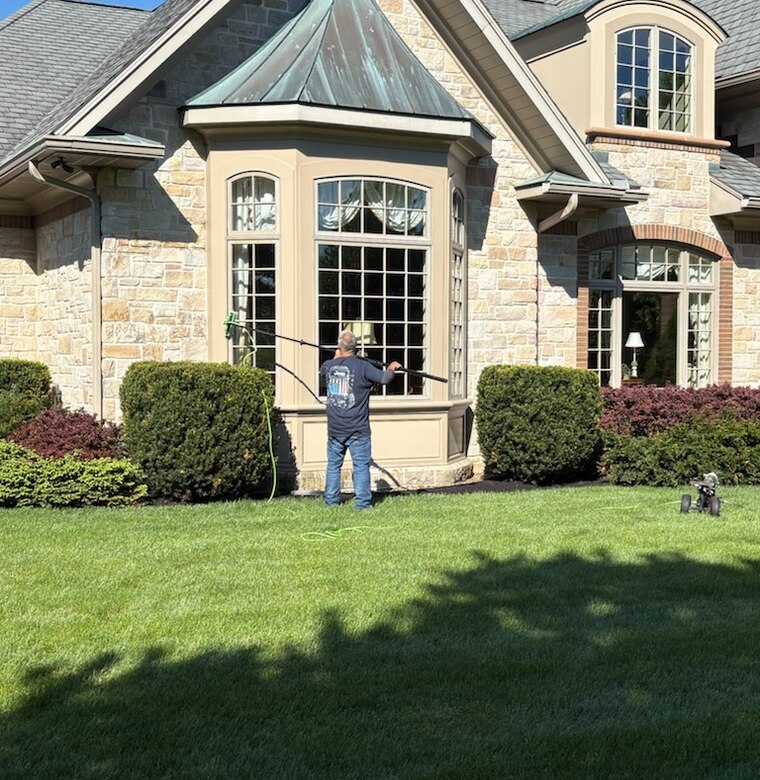 Window cleaning on a large stone home