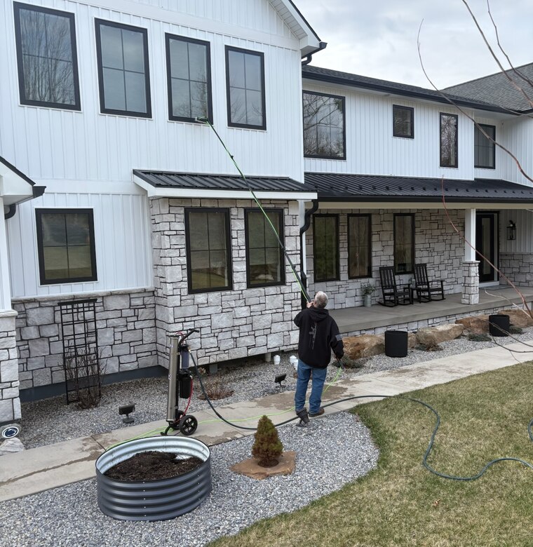 Window cleaning on a modern farmhouse